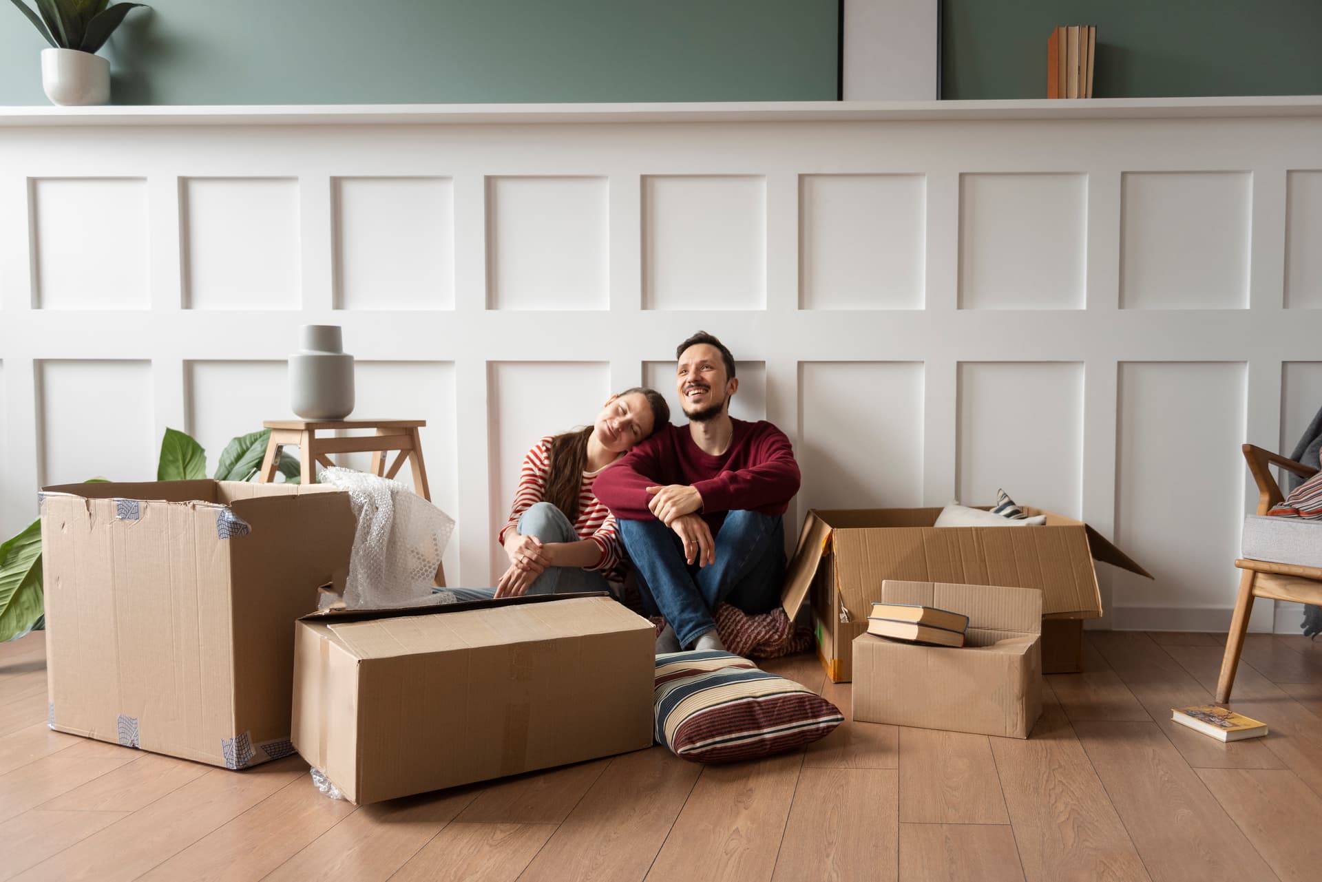 Happy family carrying moving boxes